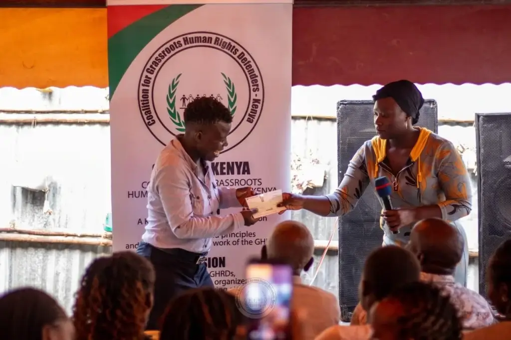 Kenyan lady receiving a certificate